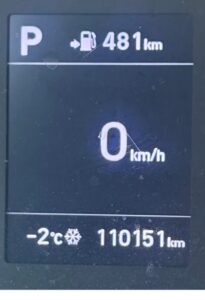 a car dashboard showing a temperature of minus two